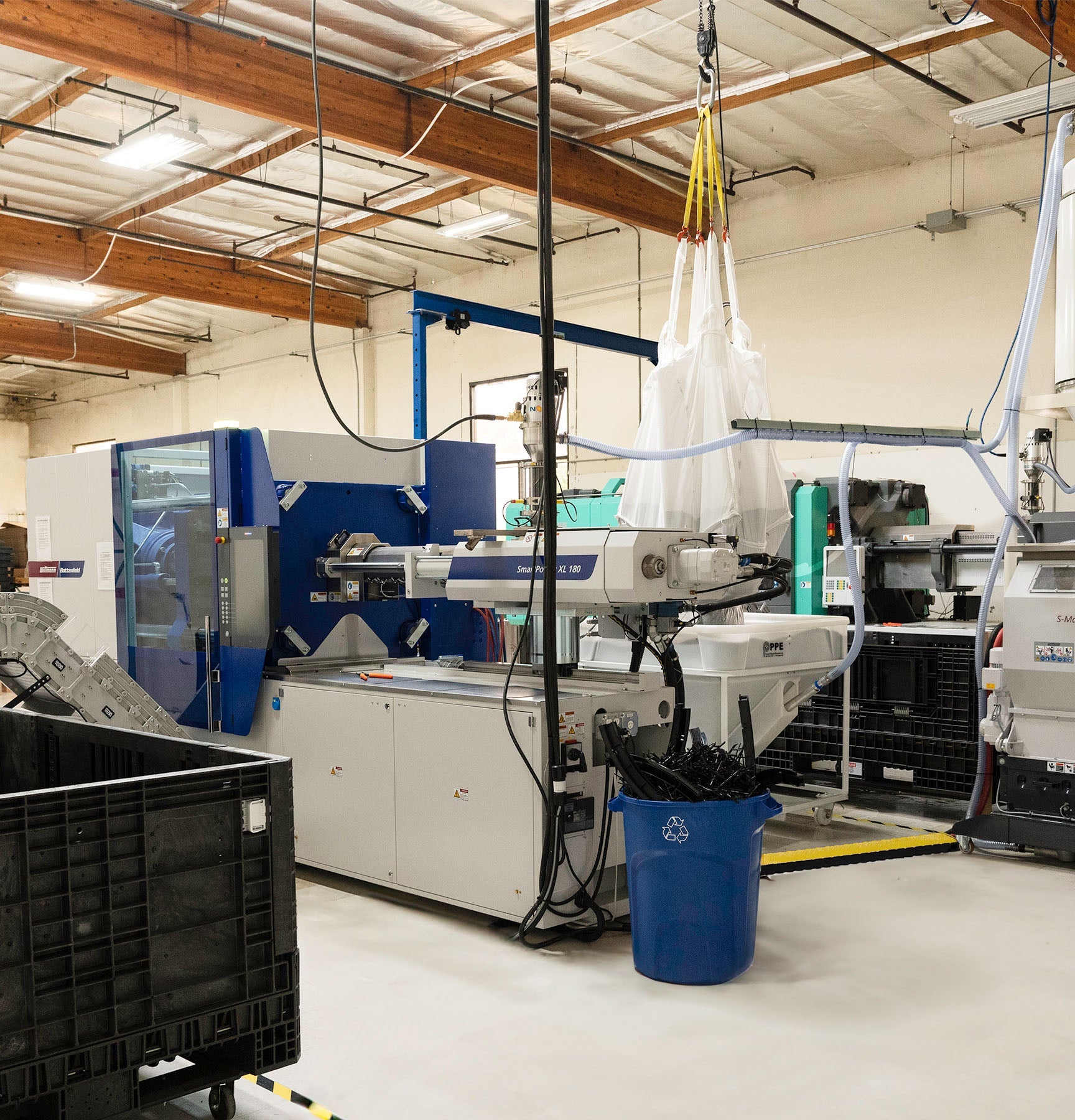 Injection molding machinery in a clean and well-lit warehouse